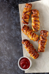 Scary sausage mummies in dough for kids party. Funny crazy Halloween food for children.