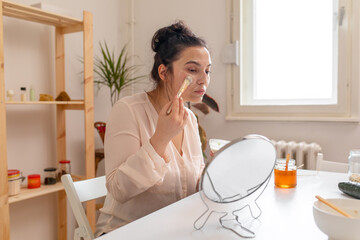 Young woman making a homemade face mask