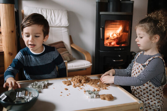 Cute little kids making cookies while having fun