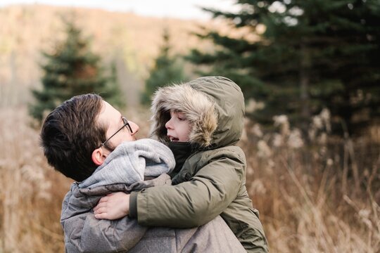 father holding his boy in his arms