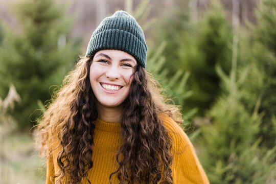 portrait of beautiful teenage girl with long curly hair and a beanie