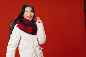 Woman in white winter jacket scarf cool studio Red isolated background 