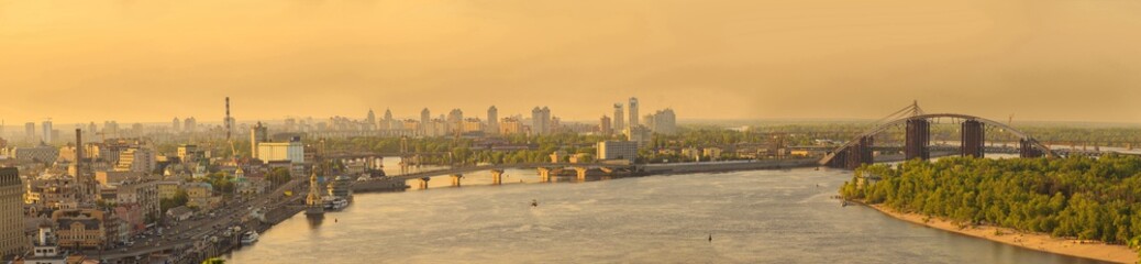 Obraz premium Big city panorama with river and bridge at sunset or sunrise