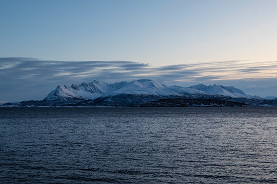 Aerial view of the nordic seaside mountain in winter at sunset