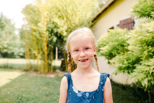 stock photo of little blonde girl with braids and glasses