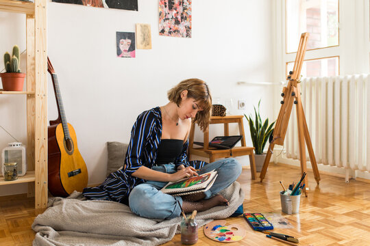 Young girl painter at home