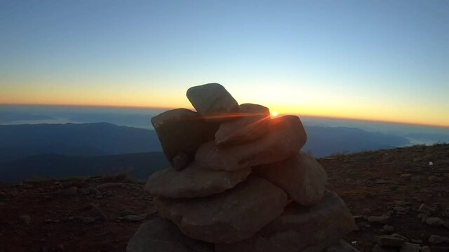 Ideal view of sunrise from 2061m of Hoverla mountain in Ukraine. The view of the sunrise from behind the stones, this view fascinates every traveler.