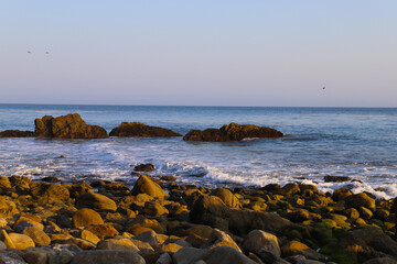 waves rolling in at the beach crashing into the rocks at El Matador beach in Malibu California