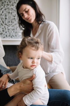 Professional Osteopath Working With Crawling Toddler And Her Mother