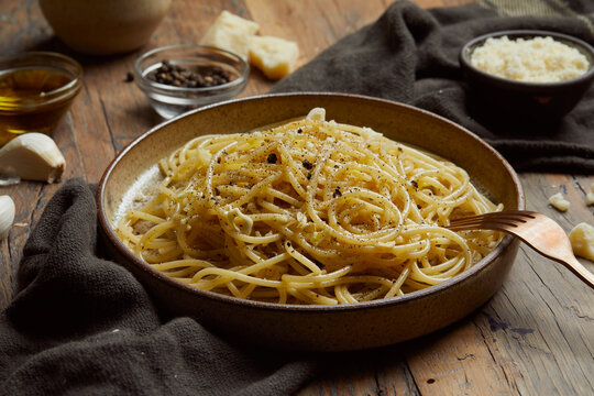 aglio e olio pasta served on a wooden table.