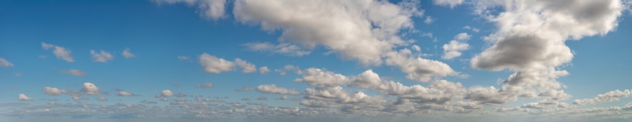 Fantastic clouds against blue sky, panorama