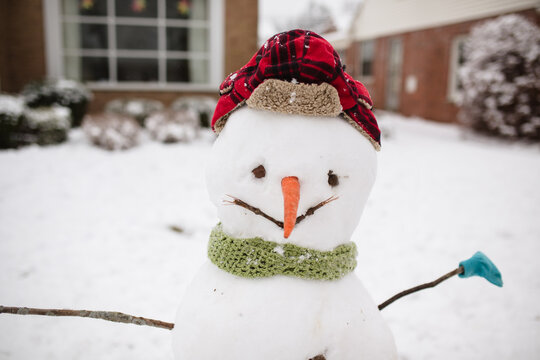 snowman with hat, scarf, gloves and carrot nose