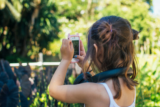 Young girl using a smart phone to take photos