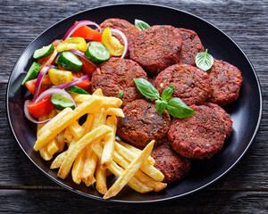 Roasted beet burger patties with french fry, salad