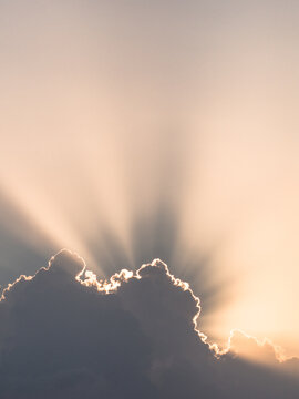The bright rays of the sun break through the clouds