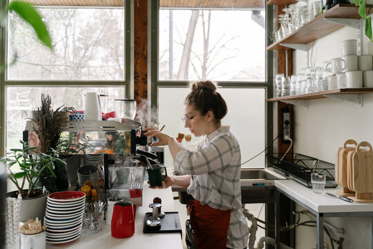 Young woman working at coffee bar