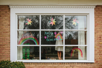 girl writes message on window
