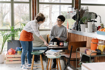 Bartender serving a guest in a coffee shop