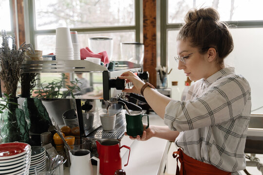Young woman working at coffee bar