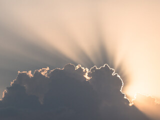 The bright rays of the sun break through the clouds