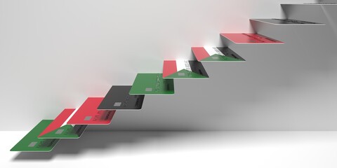 National flag of Sudan on bank cards as stairs of a staircase. Financial upward trend conceptual 3D rendering