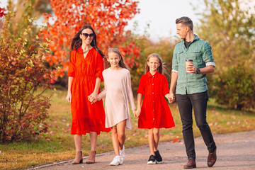 Portrait of happy family of four in autumn day