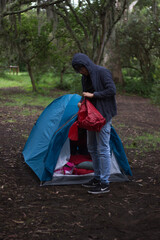 Man in a camping tent packing his storage