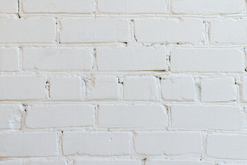 old wall of painted white bricks located horizontally