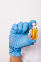 The doctor is holding a medicine bottle in his hand.