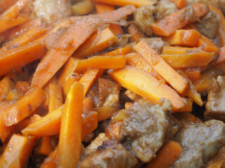 roasting meat with vegetables in a cauldron. the preparation of pilaf with meat and spices. roast.
