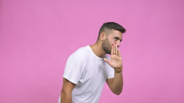 Young caucasian handsome man whispering gossip undertone, trying not to be heard