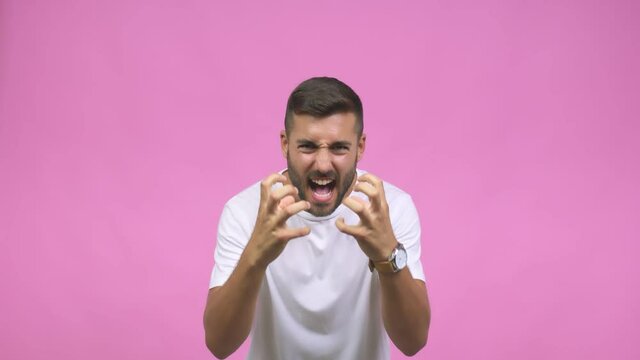 Young caucasian handsome man angry and upset, very tense, screaming furious, negative and crazy