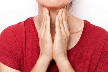 The woman is holding her throat with her hand. The woman's throat hurts.