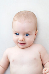 Cute baby girl lying on bed