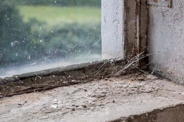 Old and dusty window with spiderwebs dirt