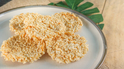 Rengginang in the white bowl. Rengginang is traditional snack from Indonesia. Made from glutinous rice formed round which is dried by drying in the sun and then fried. 