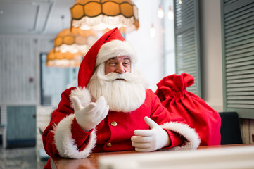 Friendly santa claus in a cafe.