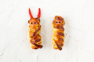 Scary sausage mummies in dough for kids party. Funny crazy Halloween food for children.