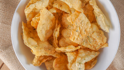 Crispy salty snacks on wooden background. close up shot