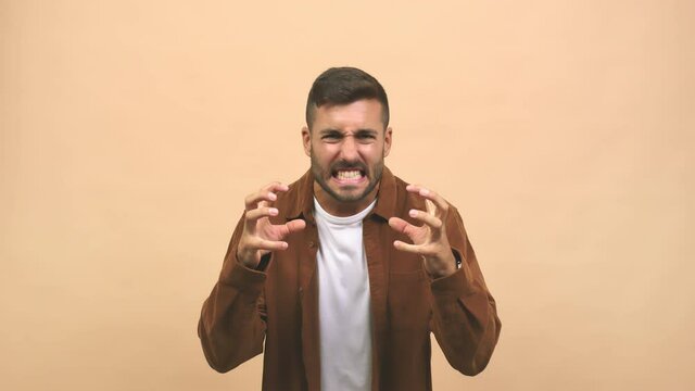 Young caucasian handsome man angry and upset, very tense, screaming furious, negative and crazy