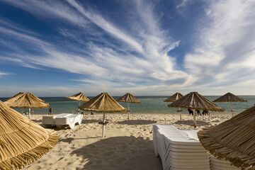 straw umbrellas on Galapa beach in Set&uacute;bal