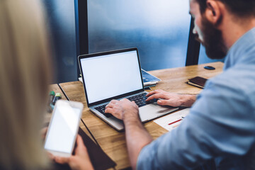 Coworkers searching information on mobile devices