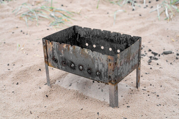 Brazier on wet sand and grass
