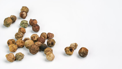 Dry green peppercorns isolated on white background board, closeup view