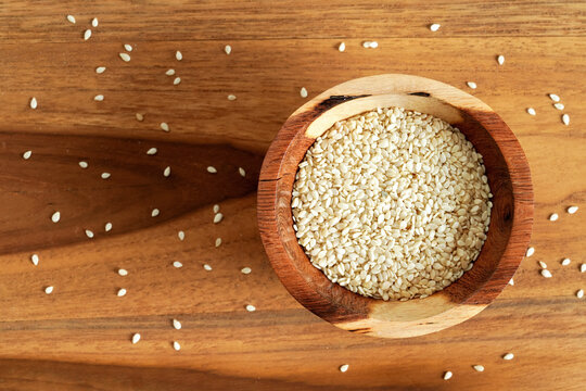 Tiny White Sesame Seeds In Small Wooden Bowl, View From Above