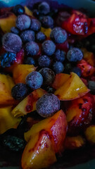 frozen blue black currant berries raspberries strawberries in bright fruit salad on plate
