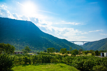 Bright sunny landscape bridge between mountains, tall structure in a canyon, montenegro