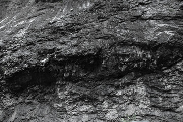 Rocky mountain pattern black and white photo with good contrast, stone texture