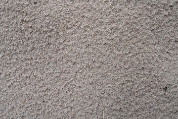 Wet gray sand on seashore texture