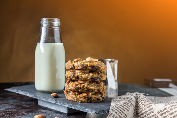 Oatmeal cookies with milk on table. Chocolate chip cookies with milk. Healthy food and drink and natural diet food. Cookie Almond and Cashew nuts.